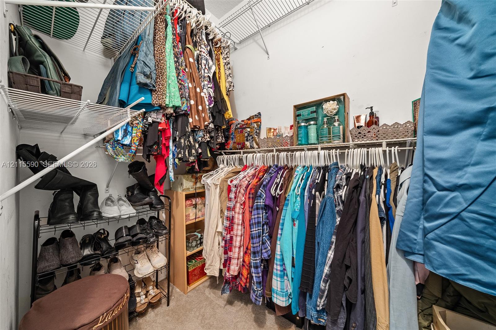Walk-in storage space featuring multi-tiered white wire shelving