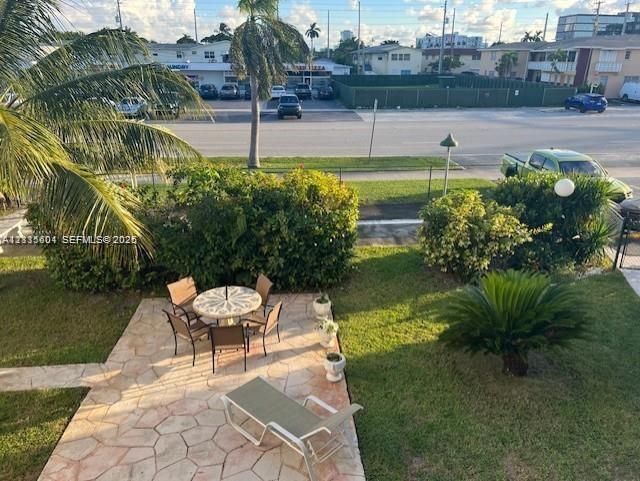 Flagstone patio featuring mature palm trees and established landscaping