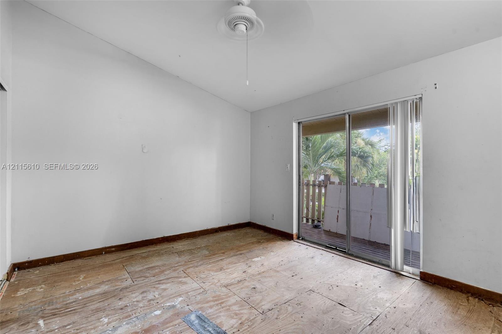 Vaulted ceilings, ceiling fan, and sliding glass door with exterior access