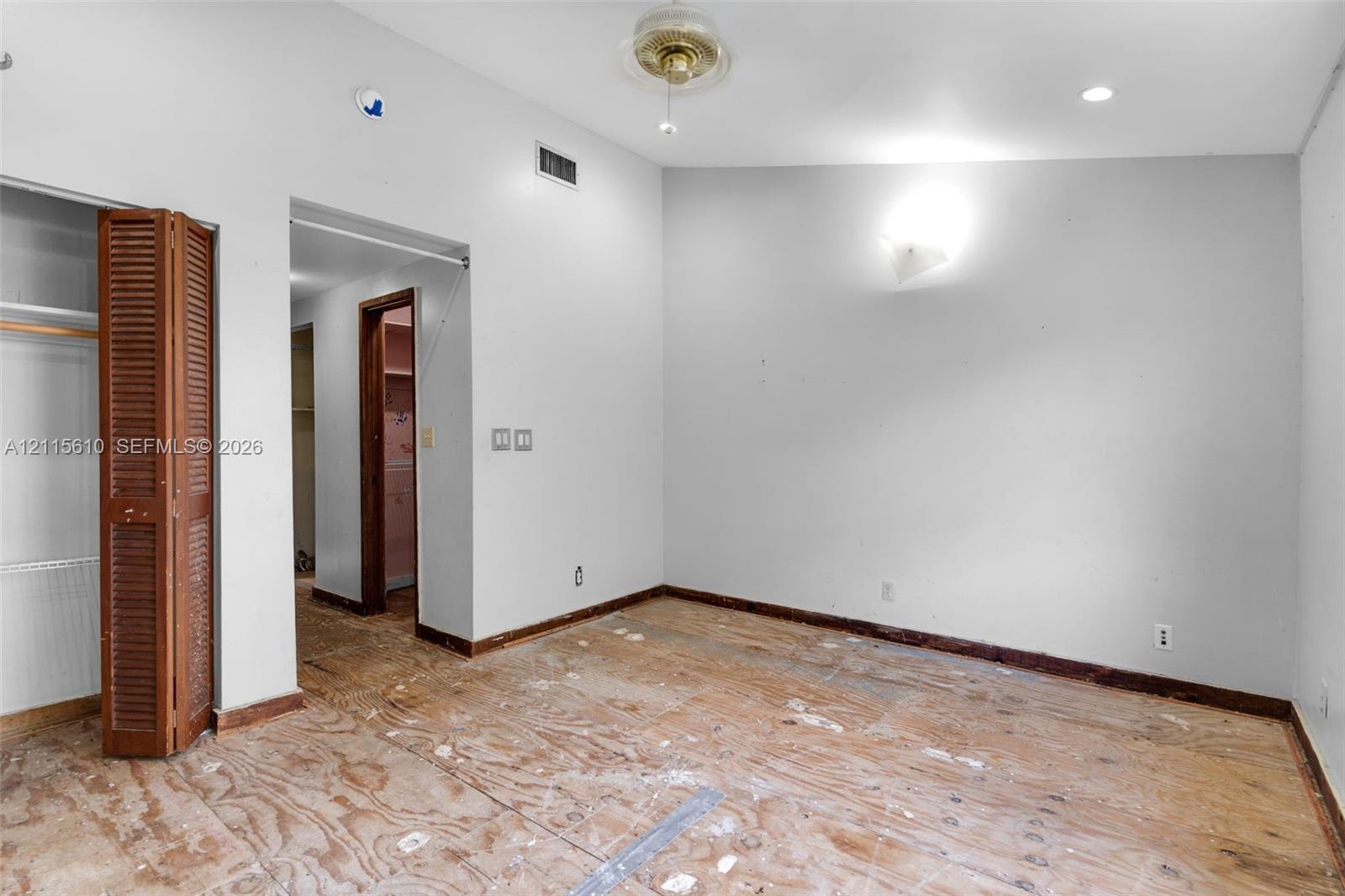 Room featuring a vaulted ceiling, recessed lighting, ceiling fan, and louvered bifold closet doors