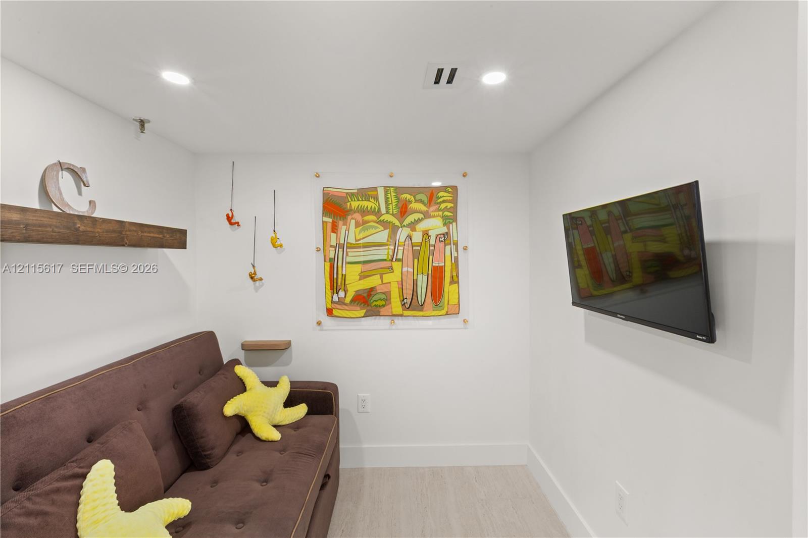 Recessed ceiling lighting, wood-finish flooring, and a wall-mounted wooden floating shelf