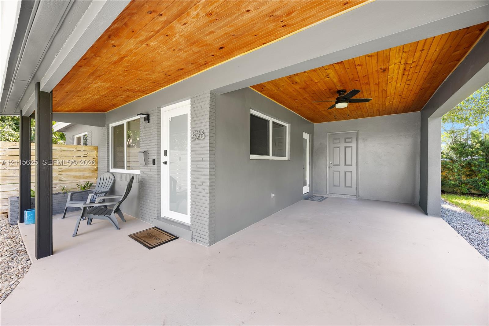 Covered patio featuring a wood-plank ceiling, recessed lighting, a ceiling fan, and painted brick exterior walls