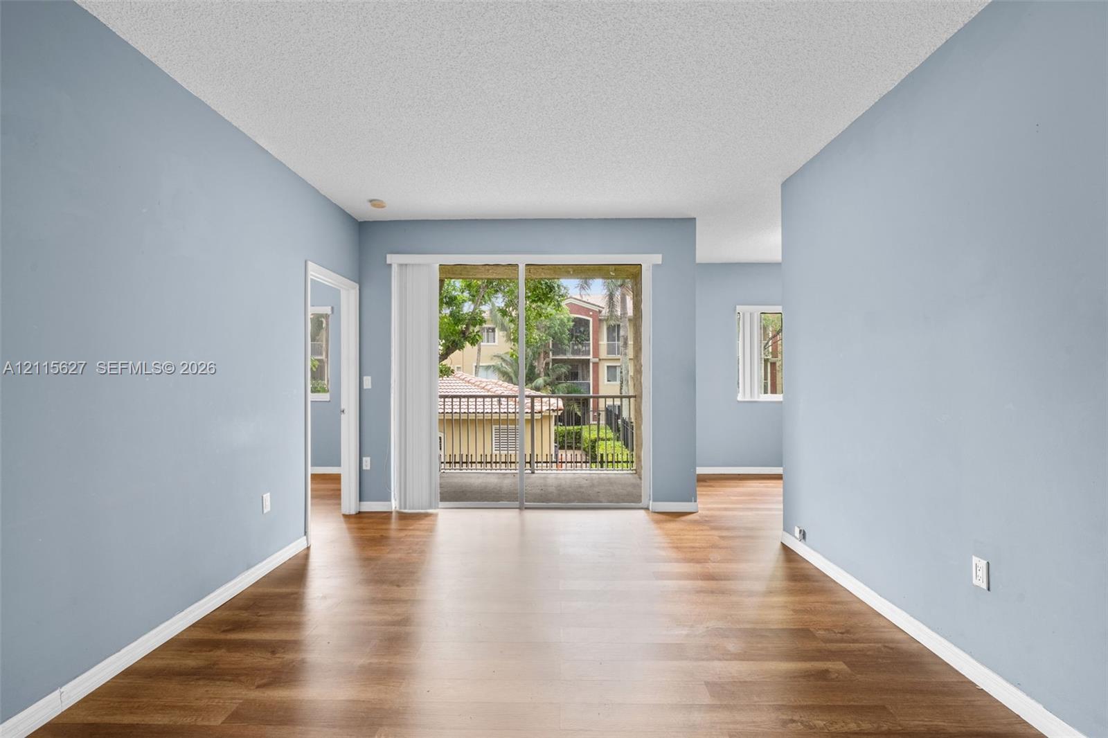 Wood-finish flooring, sliding glass patio door, and exterior balcony