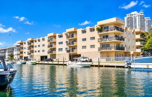 Waterfront multi-story building featuring private balconies, bulkhead docking, and covered ground-level parking