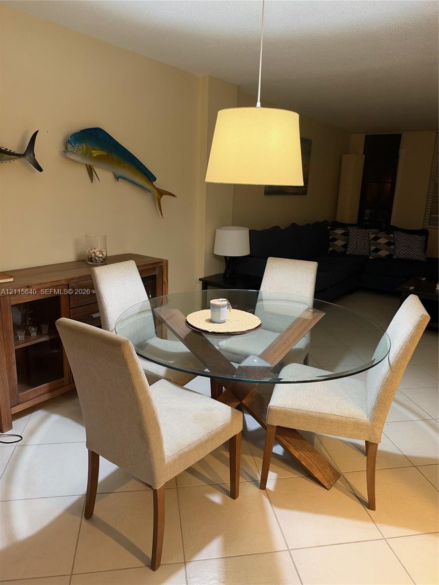 Large-format tile flooring and suspended drum pendant lighting