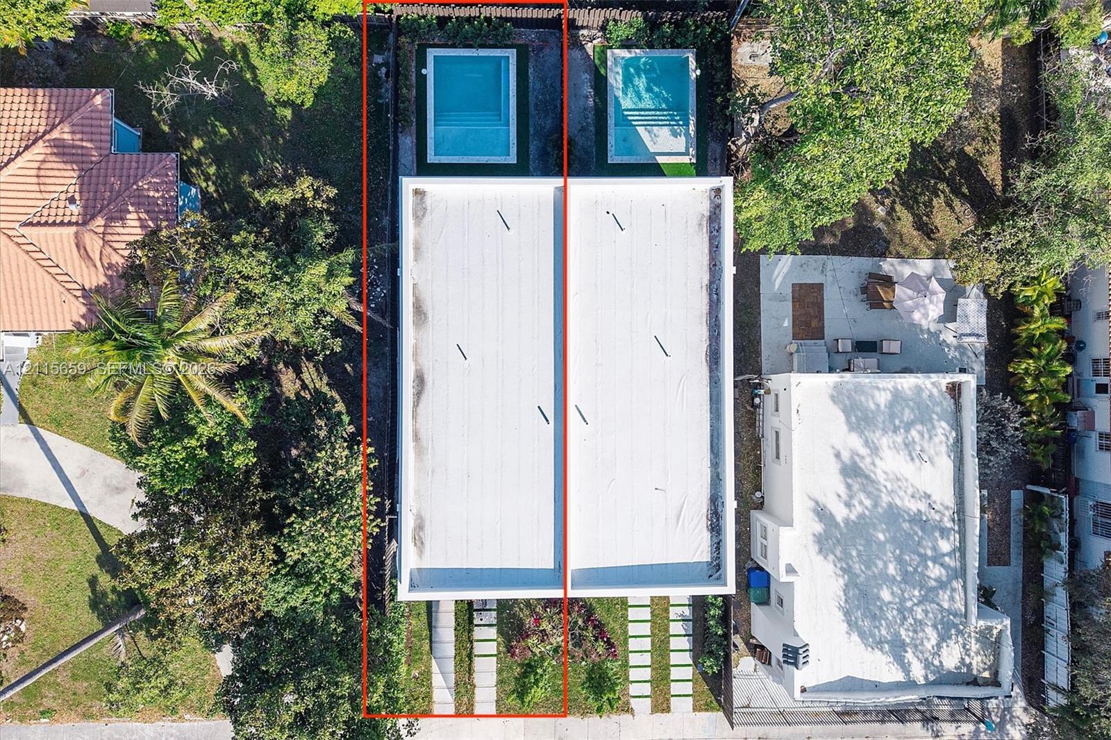 Aerial perspective of a property featuring a flat roofline, individual in-ground swimming pools, and concrete paver driveway strips