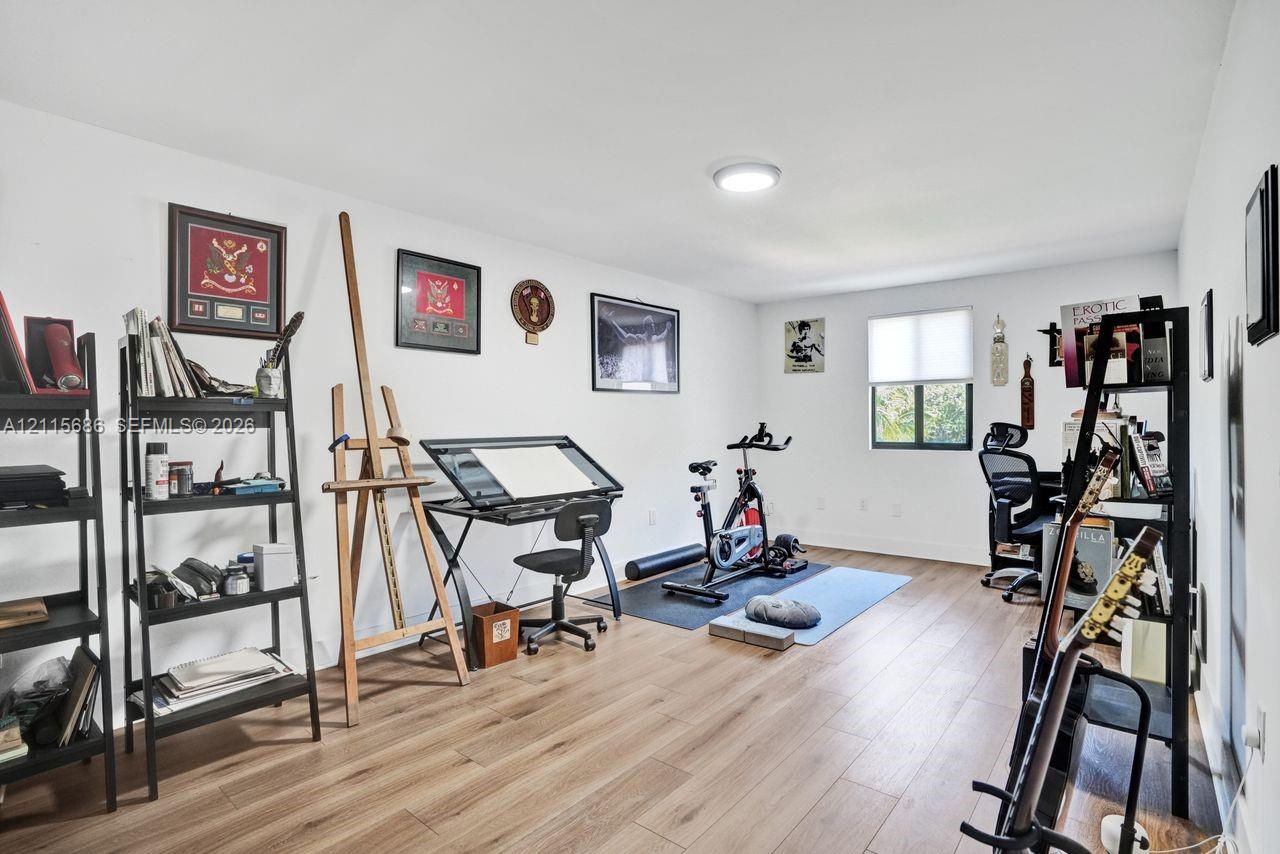Multi-purpose room featuring wood-finish flooring, neutral walls, and a recessed ceiling light