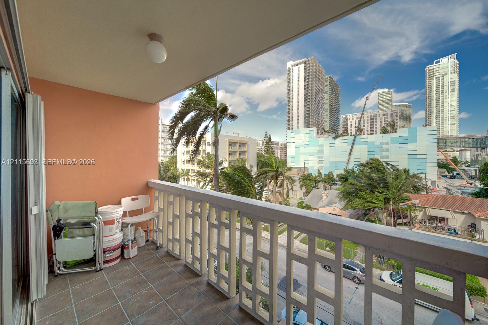 Covered balcony featuring tile flooring and a decorative geometric balustrade