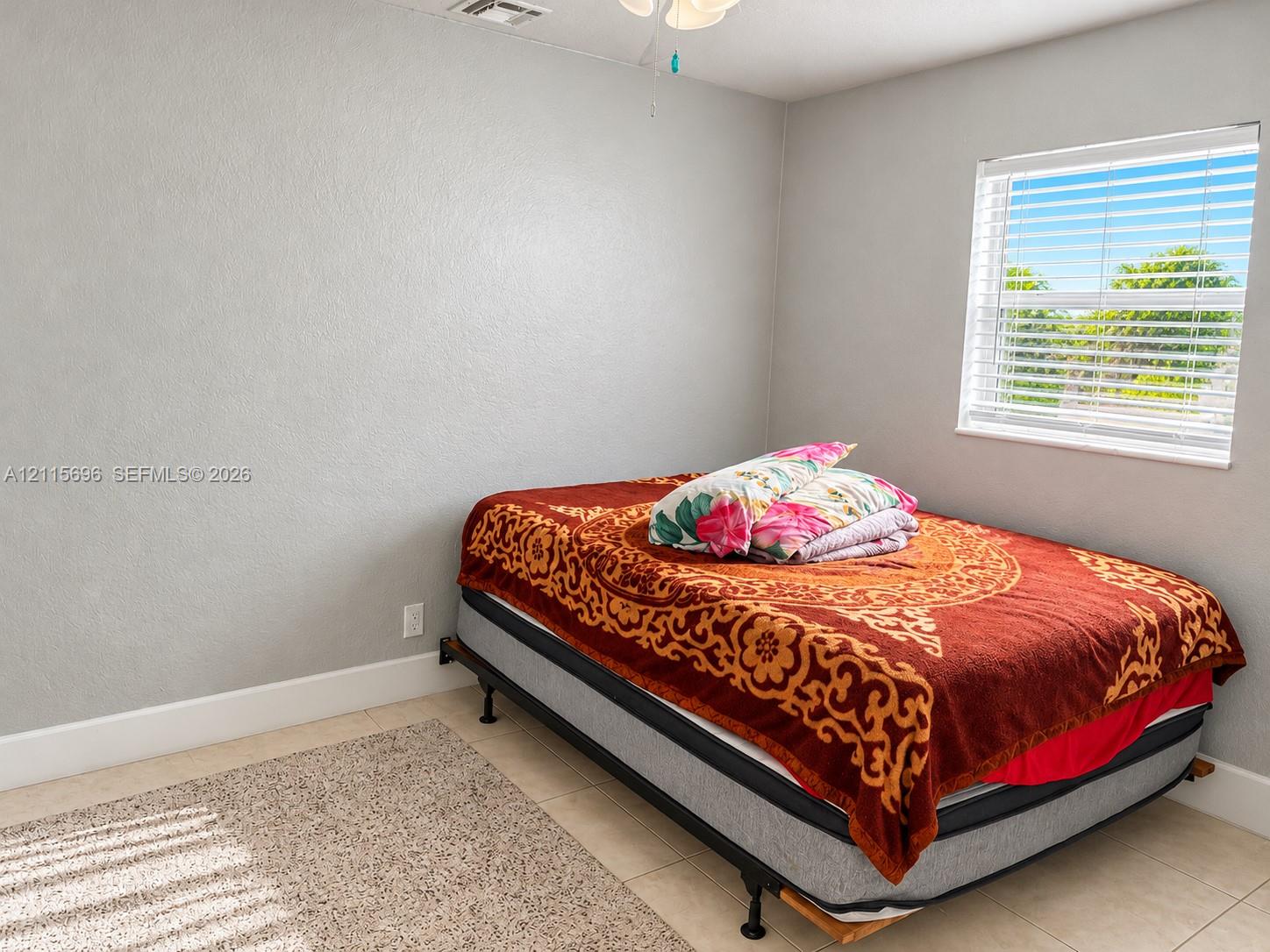Neutral wall finishes, ceramic tile flooring, and horizontal window blinds