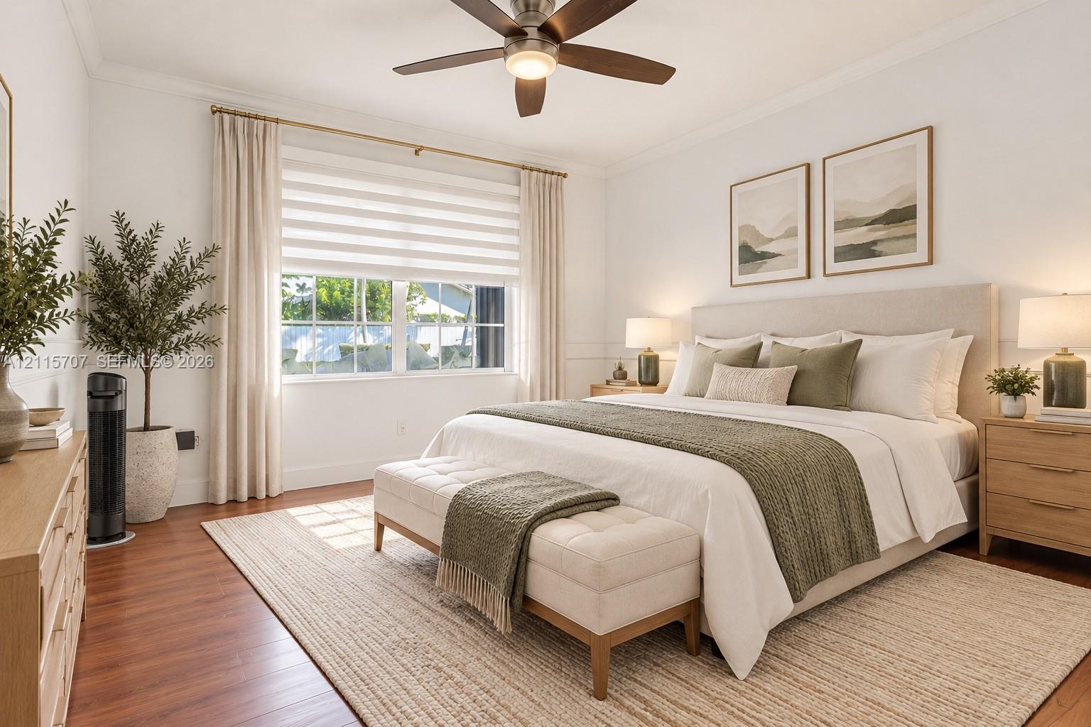 Neutral-toned interior featuring wood-finish flooring, a multi-blade ceiling fan with integrated lighting, dual-pane windows, and minimalist wall molding