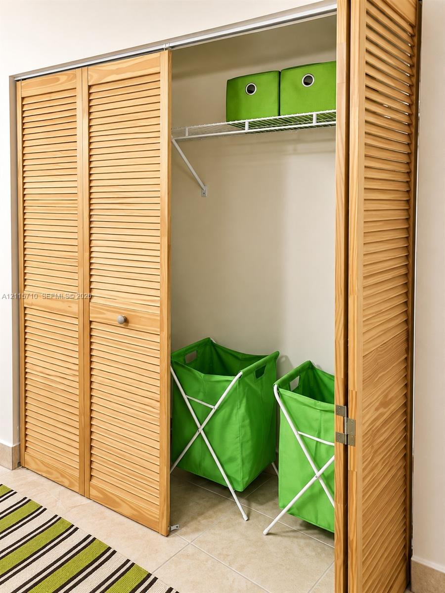 Closet featuring light-finish wood bi-fold louvered doors and wire shelving
