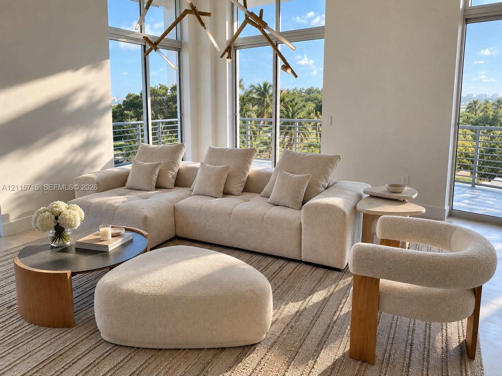Floor-to-ceiling windows, sculptural multi-arm chandelier, and polished neutral tile flooring