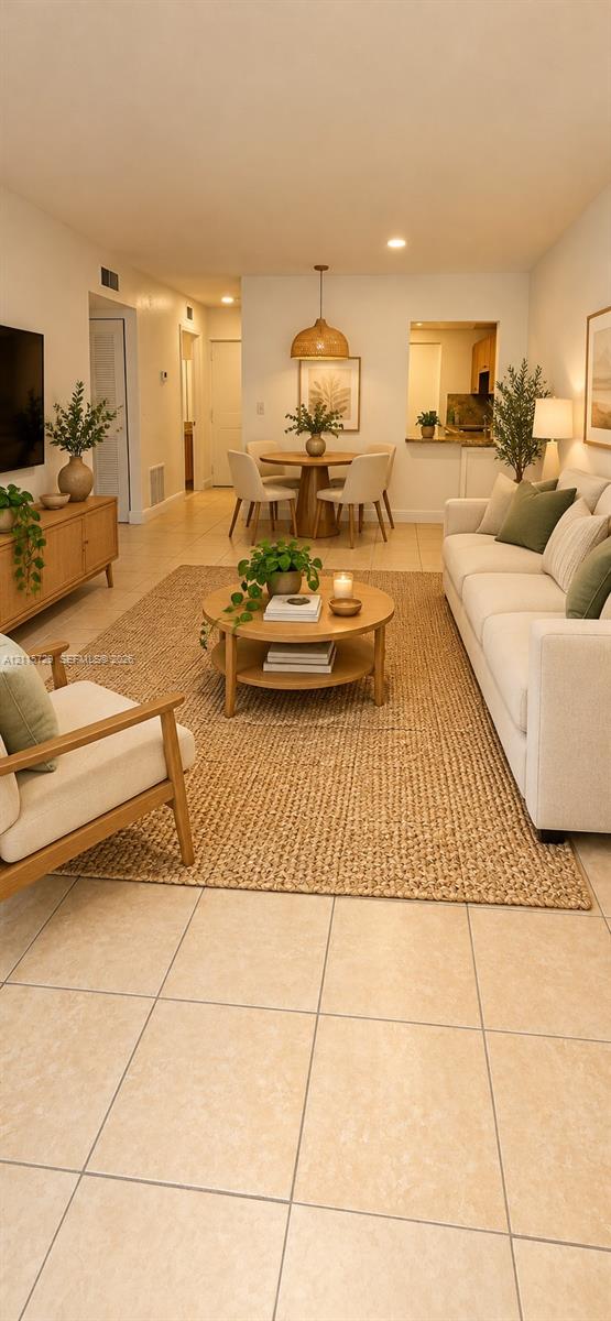 Large format tile flooring, recessed lighting, and a pendant light fixture