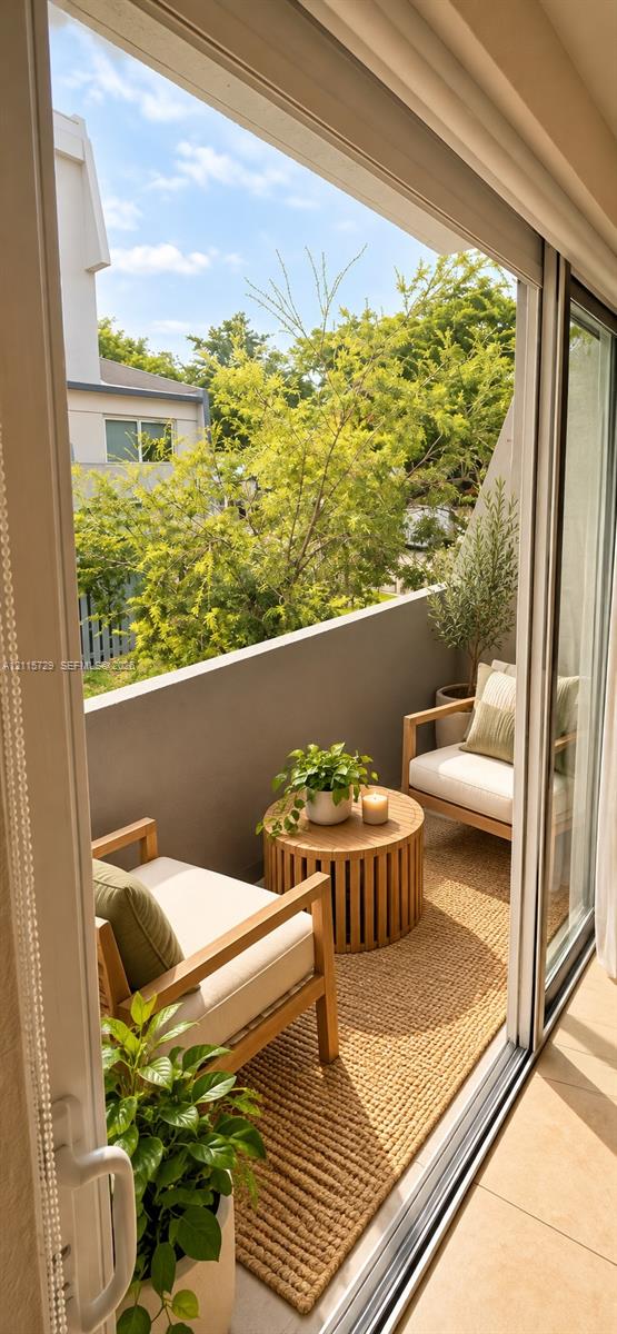 Balcony featuring sliding glass door access, concrete parapet wall, and tile flooring