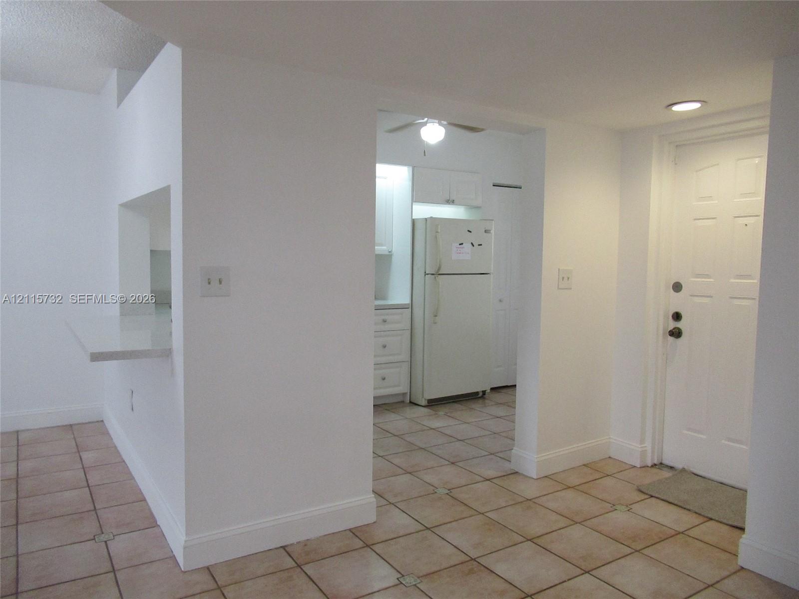 Ceramic tile flooring, built-in breakfast bar with stone-finish surface, recessed lighting, and six-panel exterior entry door Ceramic tile flooring, built-in breakfast bar with stone-finish surface, recessed lighting, and six-panel exterior entry door