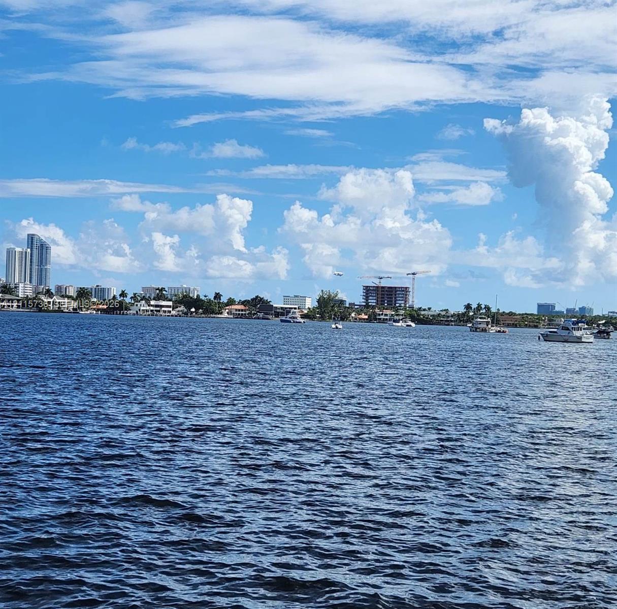 Wide-reaching waterfront position featuring expansive aquatic scenery, nautical traffic, and distant coastal architecture
