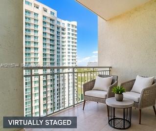 Covered balcony featuring tile flooring and metal railings