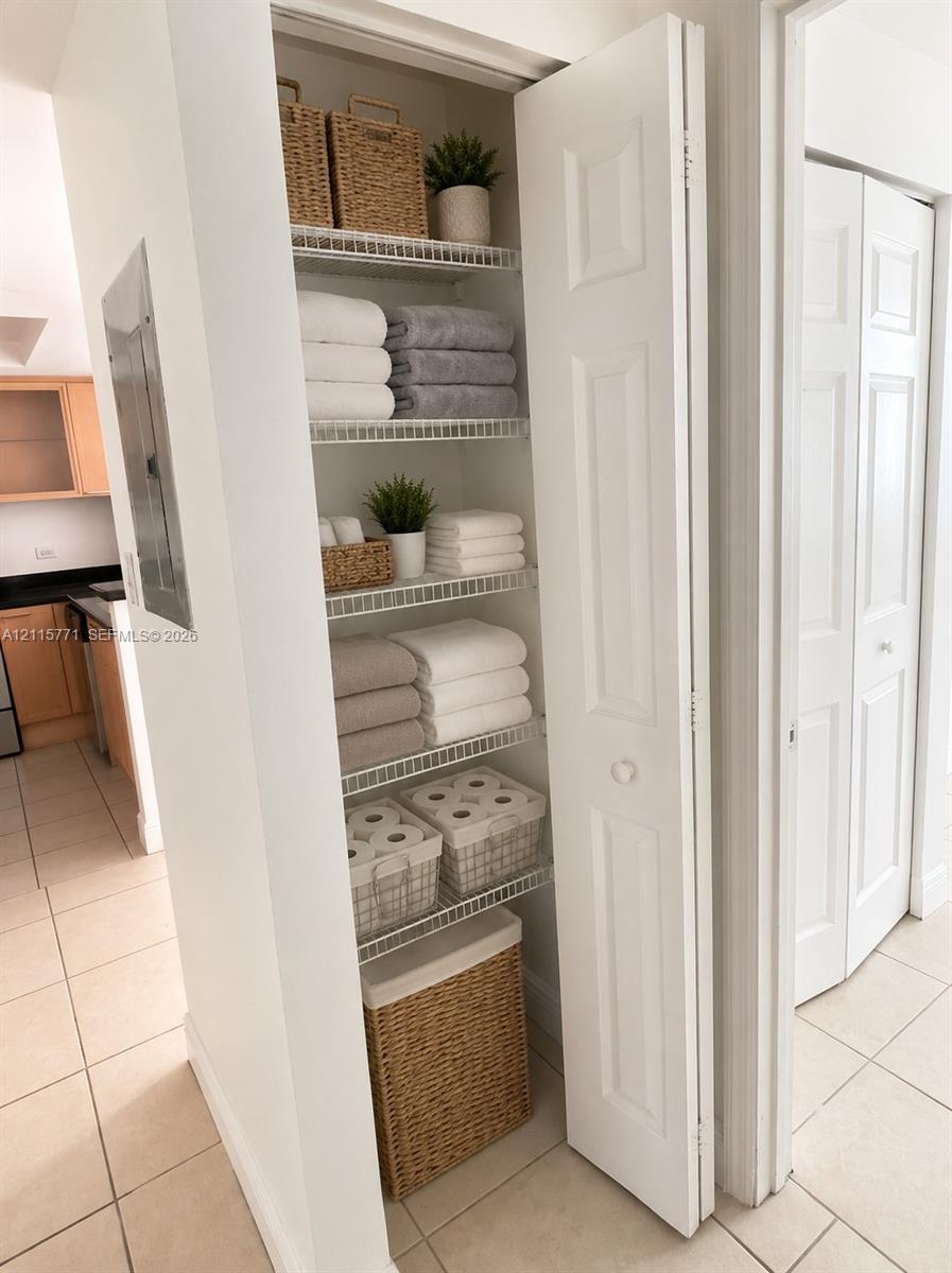 Built-in storage closet featuring white bi-fold doors and ventilated wire shelving