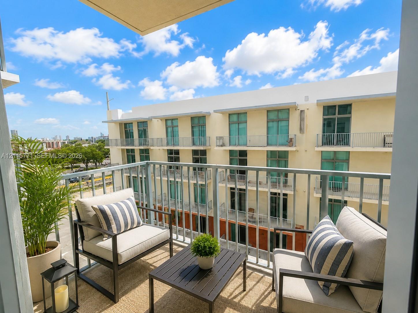 Private balcony featuring metal railings and concrete flooring