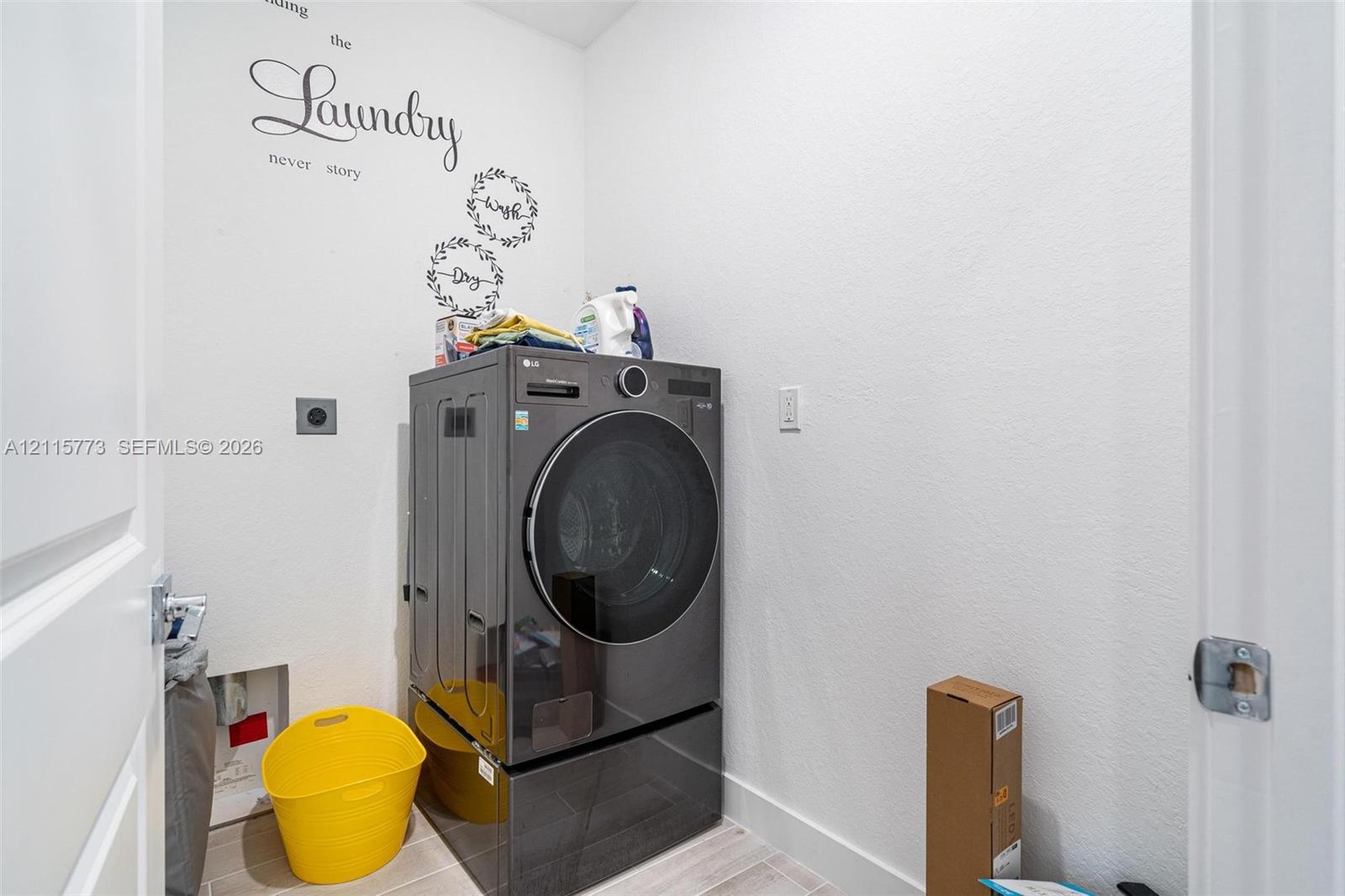 Dedicated utility area featuring tile flooring and integrated washer hookups
