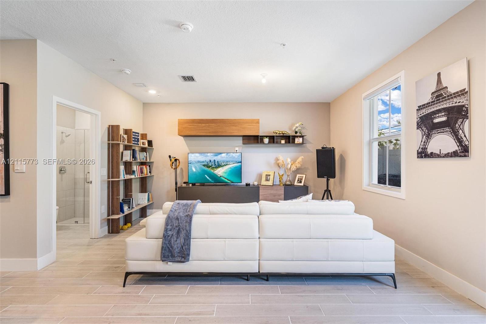 Interior space featuring tile flooring, built-in wooden shelving, and wall-mounted cabinetry