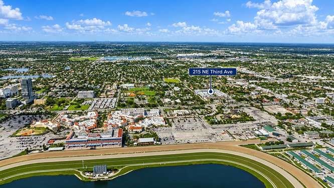 Aerial perspective showing proximity to regional horse racing track, municipal water features, and expansive urban infrastructure
