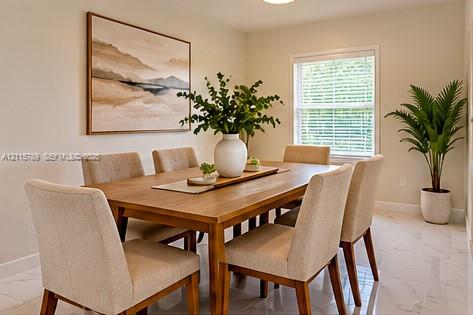 Neutral-toned interior space featuring light-colored stone-finish flooring, a single window with horizontal blinds, and smooth-finished walls