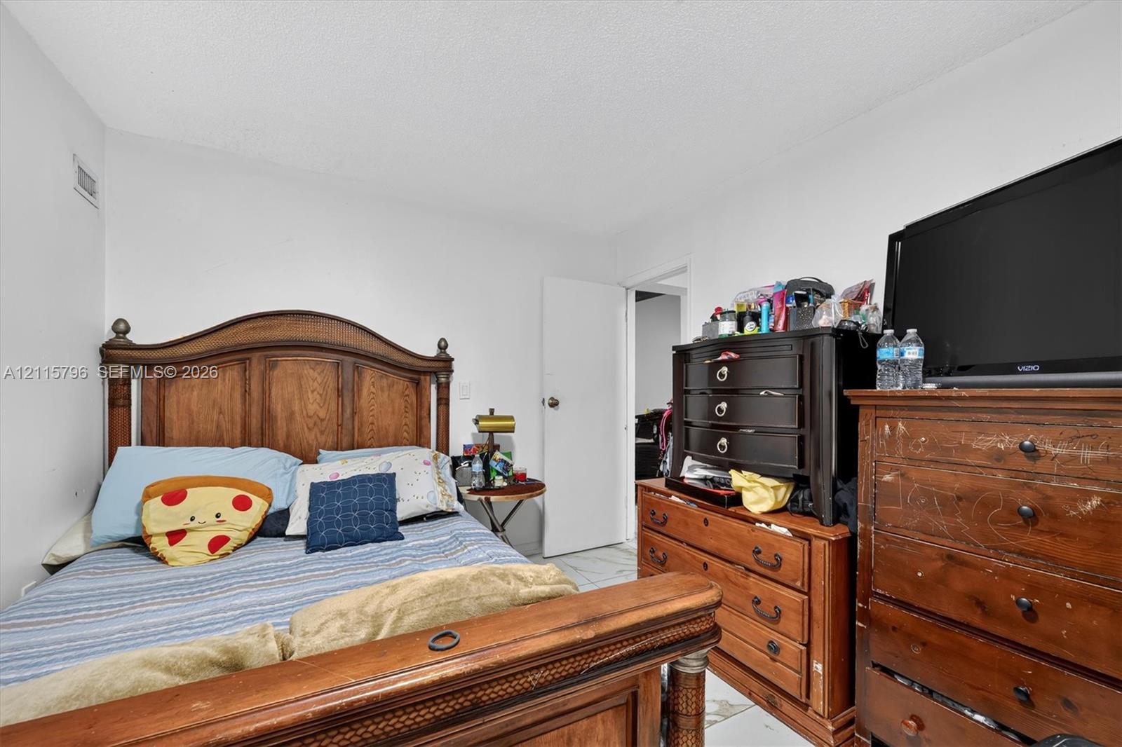 Bedroom with white walls and light-toned flooring