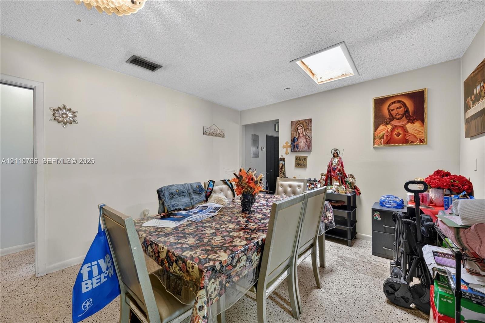 Interior space featuring a skylight, textured ceiling, and neutral wall tones