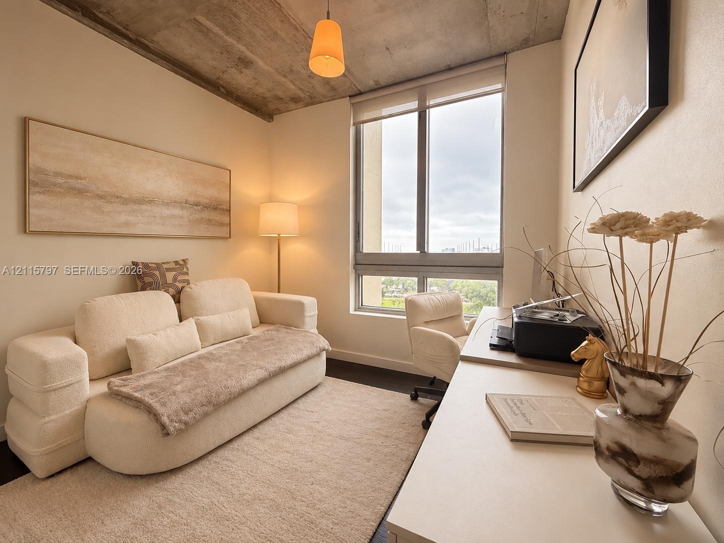 Exposed concrete ceiling, large window with integrated roller shade, pendant lighting, and dark-toned flooring