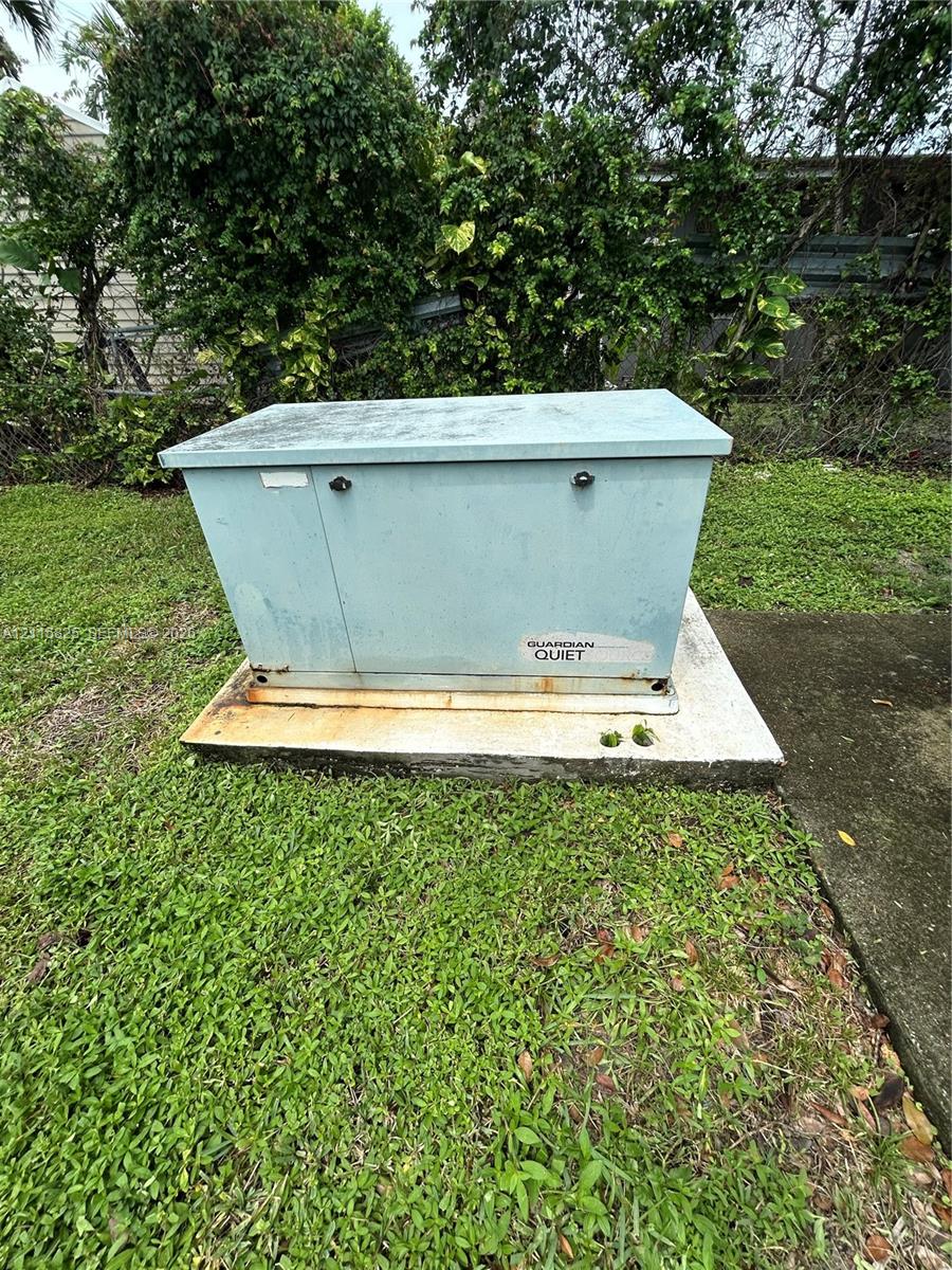 Standby generator housed in a protective metal enclosure on a concrete pad