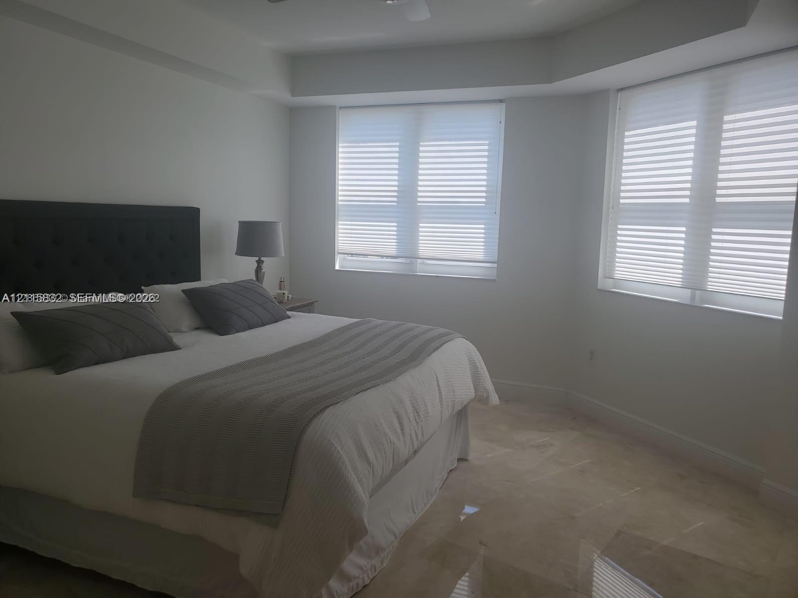 Neutral-toned flooring, multi-pane windows, and recessed ceiling detailing