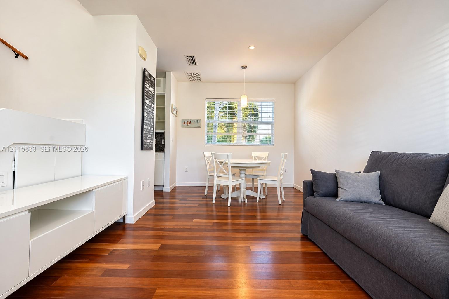 Hardwood flooring, custom built-in white cabinetry, and recessed lighting