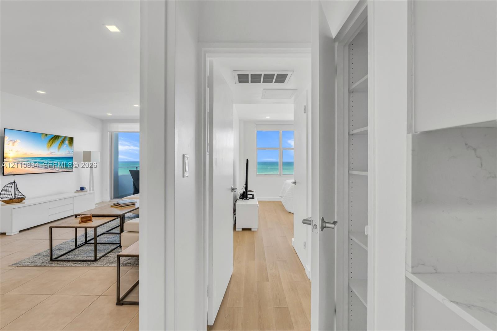 Built-in pantry with adjustable shelving, recessed lighting, and wood-finish flooring