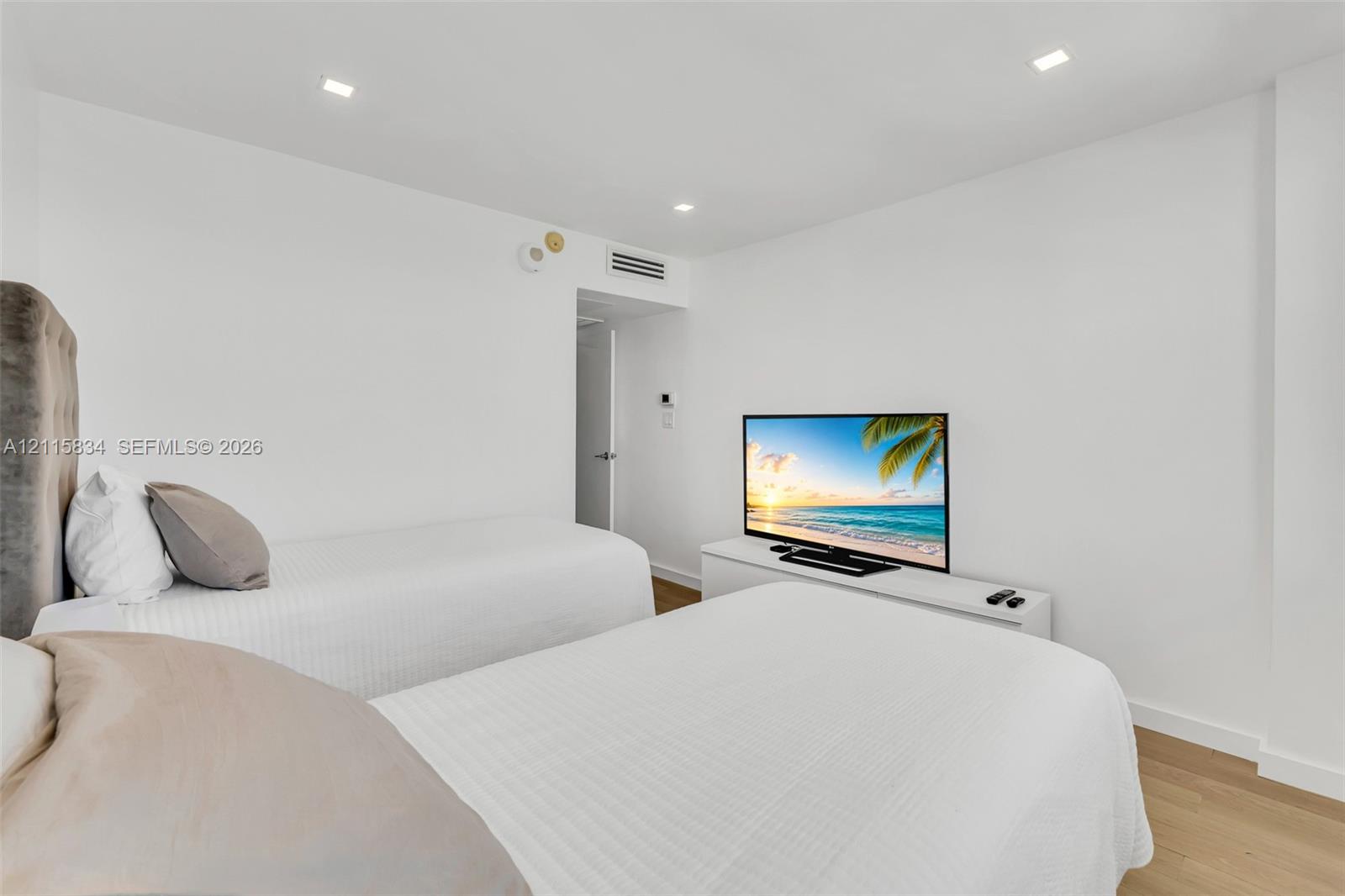 Interior space featuring recessed lighting, wood-finish flooring, and crisp white walls