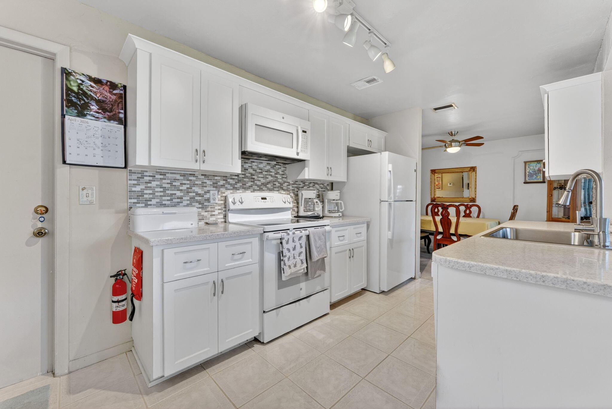 White Shaker Cabinets, White appliances and Corian Counter tops