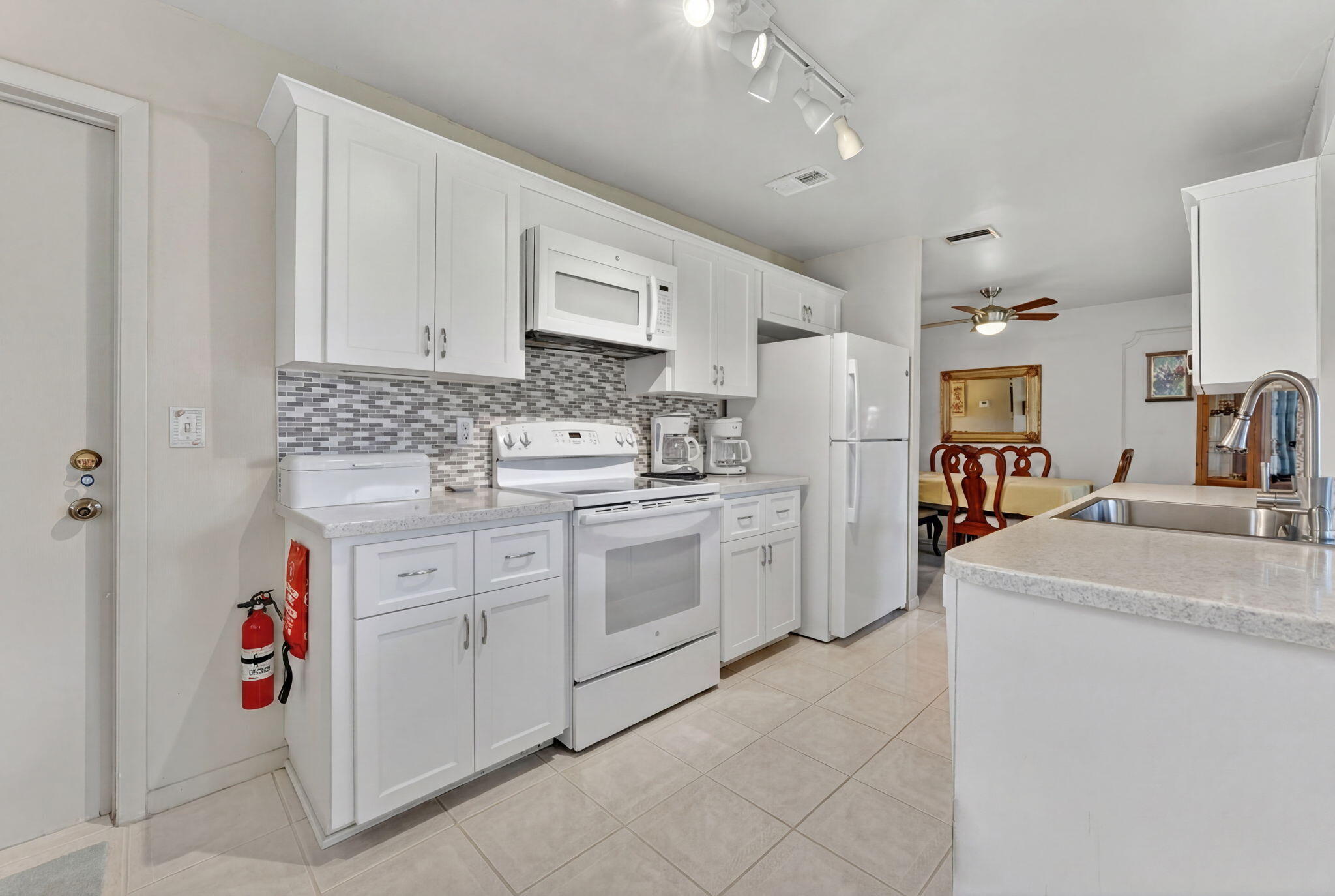 White Shaker Cabinets, White appliances and Corian Counter tops