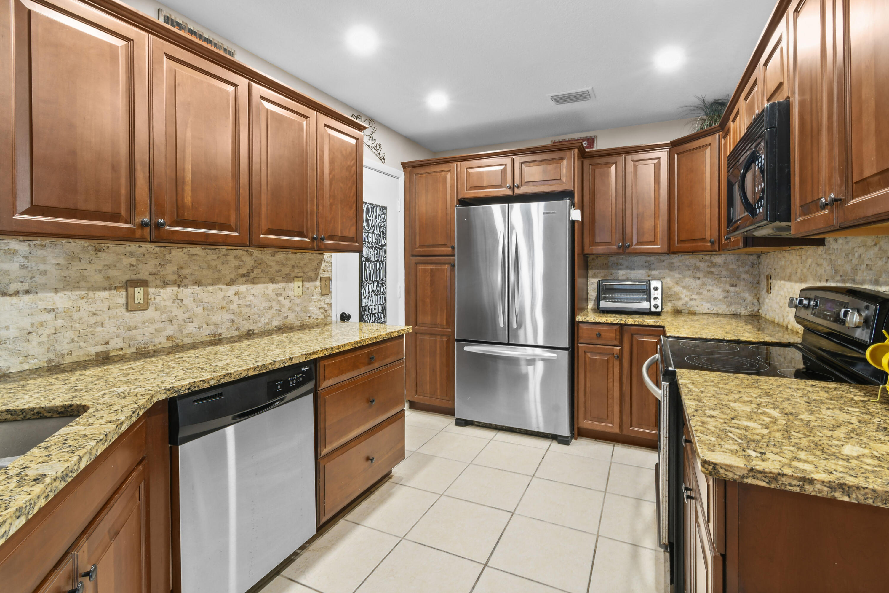 Kitchen with stainless steel appliances. New lighting