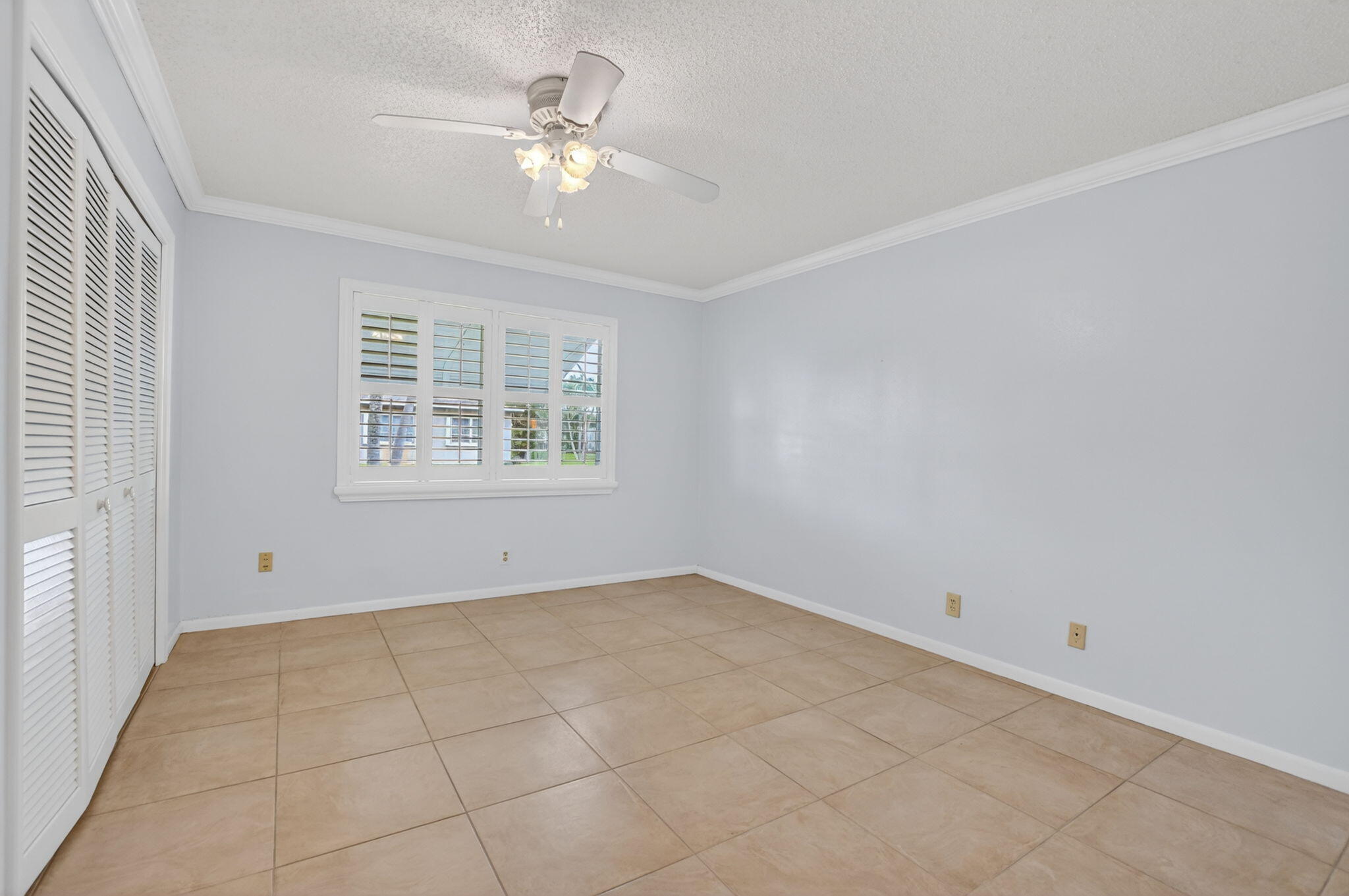 Large 2nd Bedroom - spy the plantation shutters + wall closet
