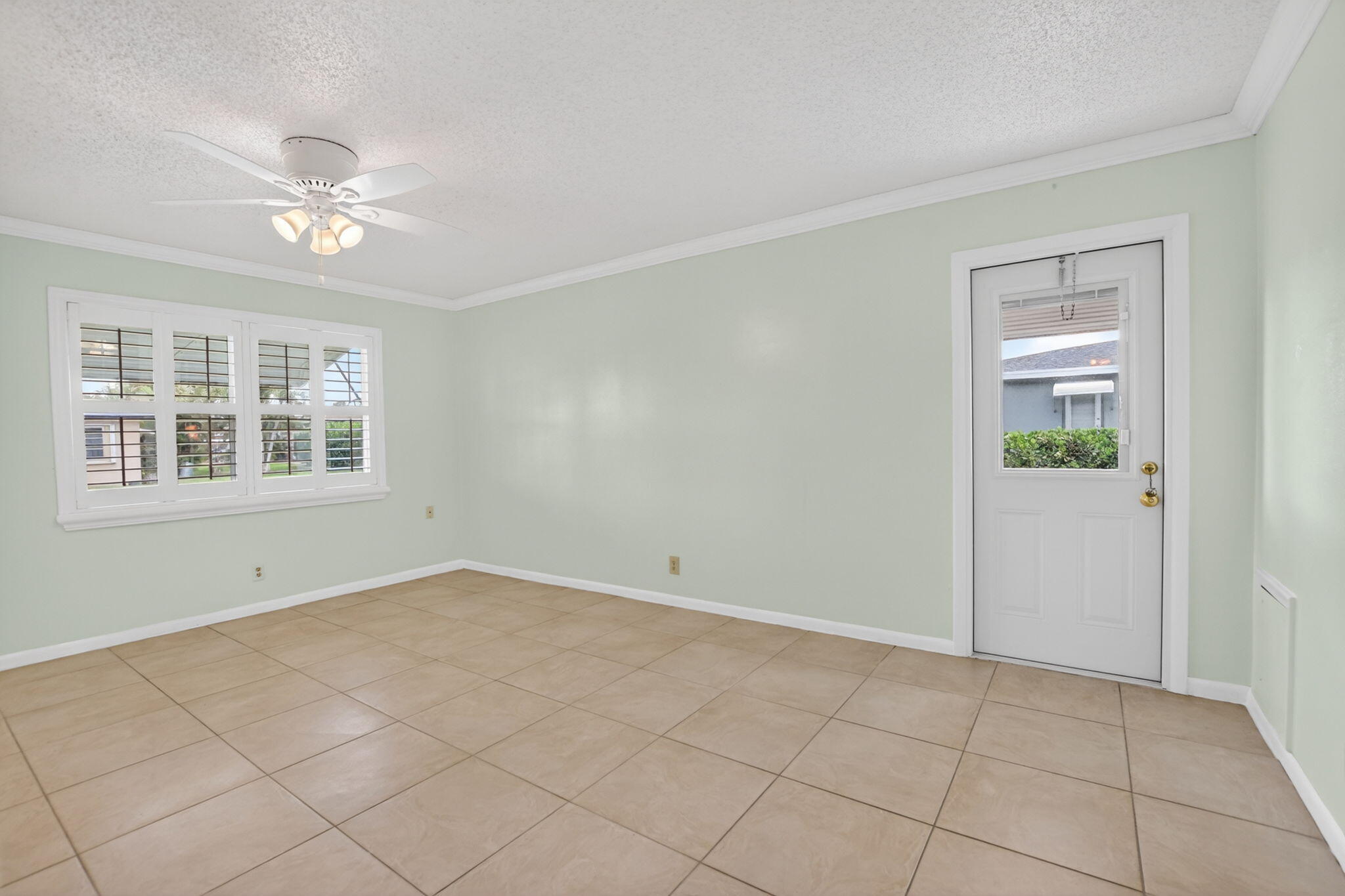 Large Primary bedroom -plantation shutters + tile floors throughout