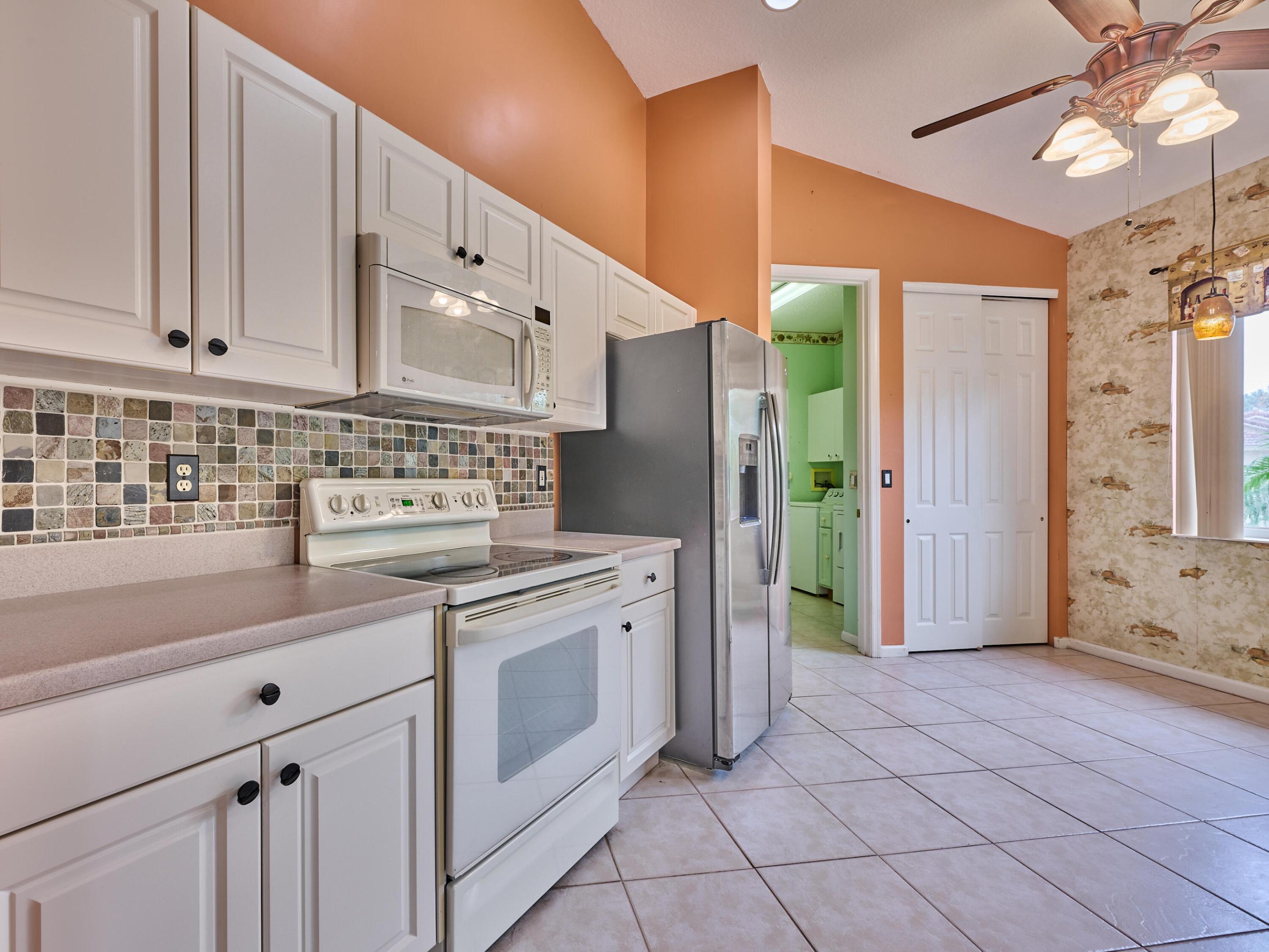 Corion counters, tiled backsplash, white cabinets
