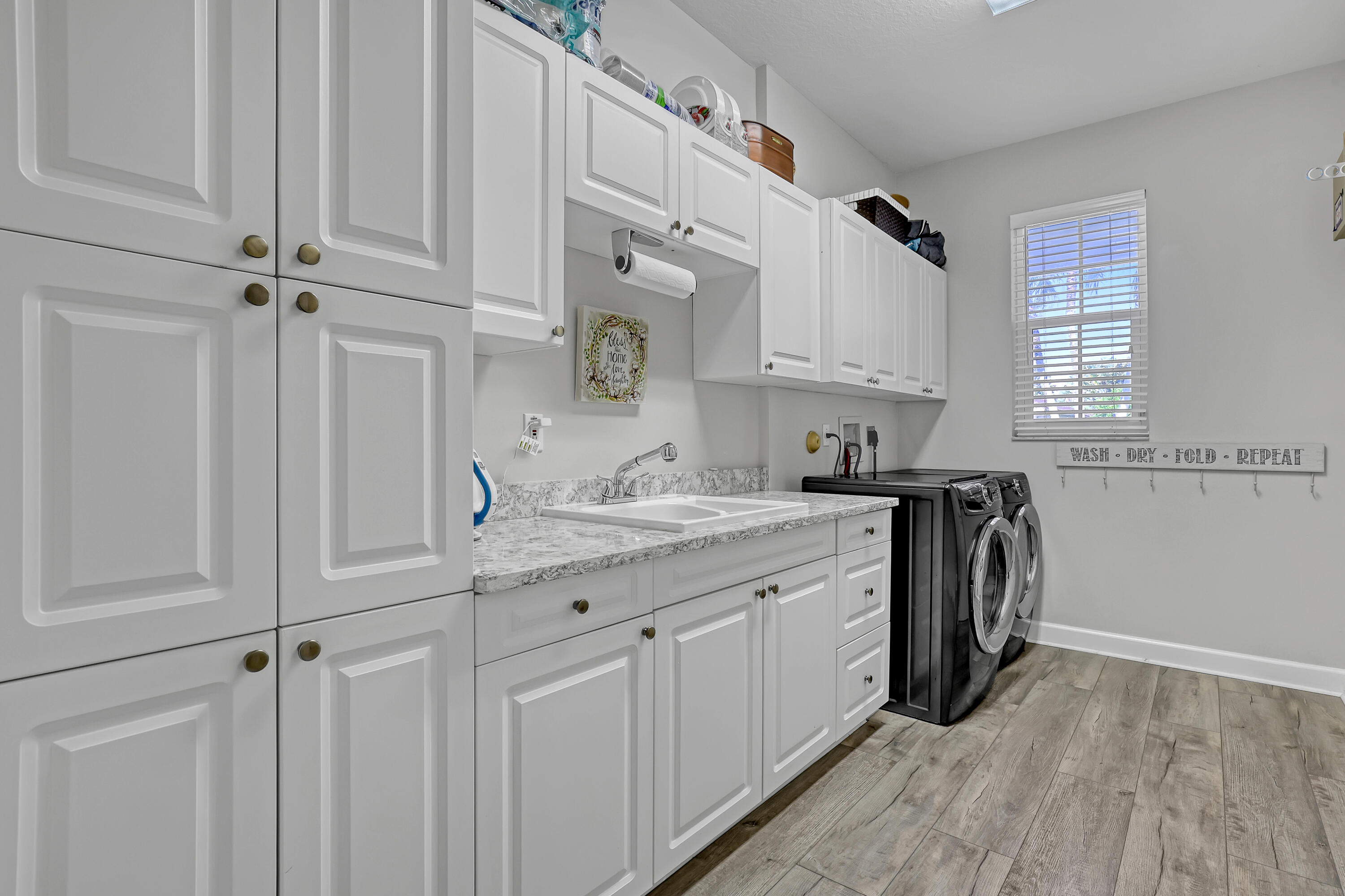 Laundry room with sink and storage