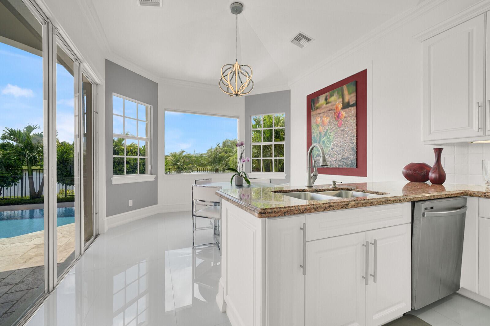 Kitchen featuring white cabinetry, granite countertops, stainless steel appliances, and a double basin sink