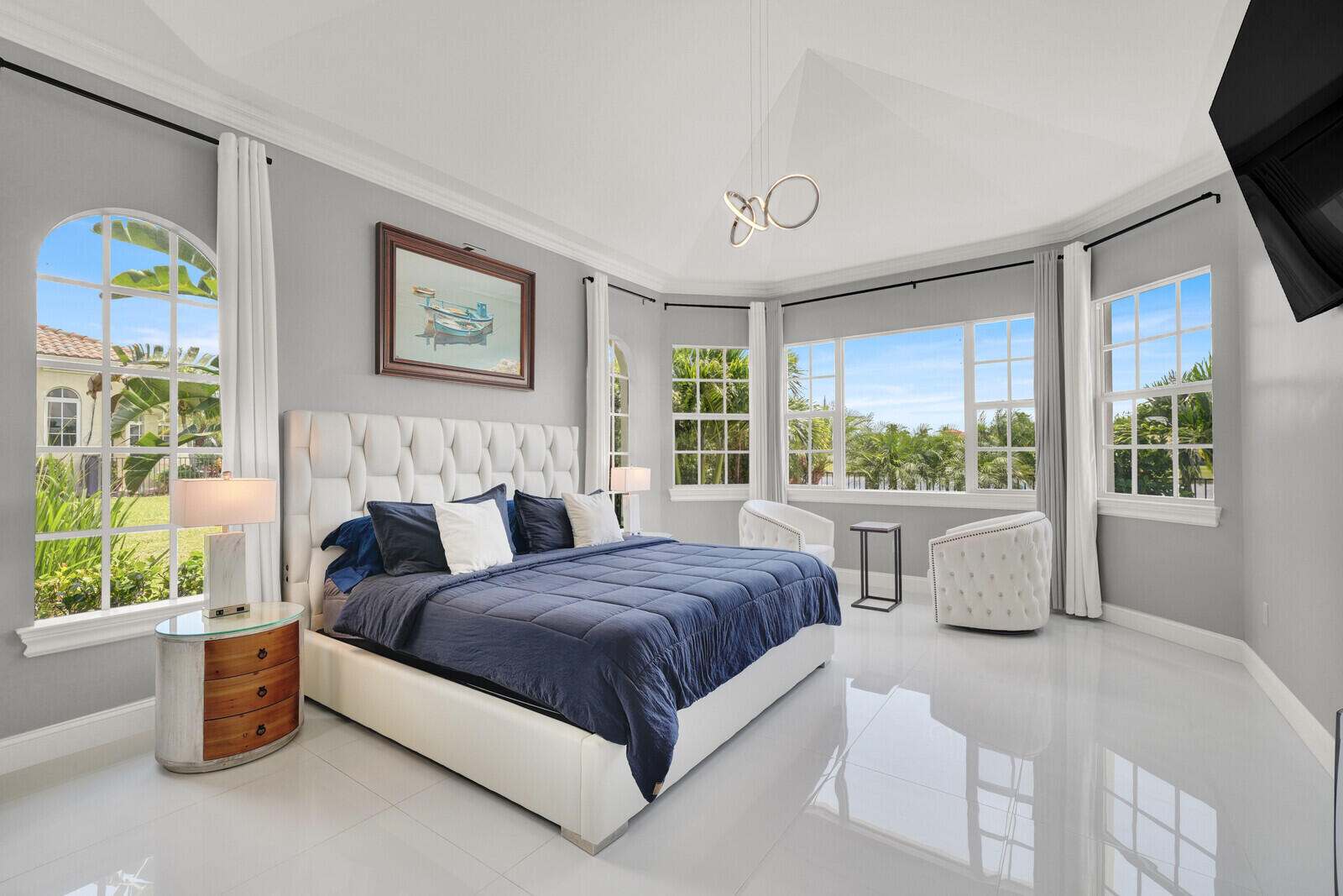 Vaulted ceiling with crown molding, featuring a contemporary pendant light fixture