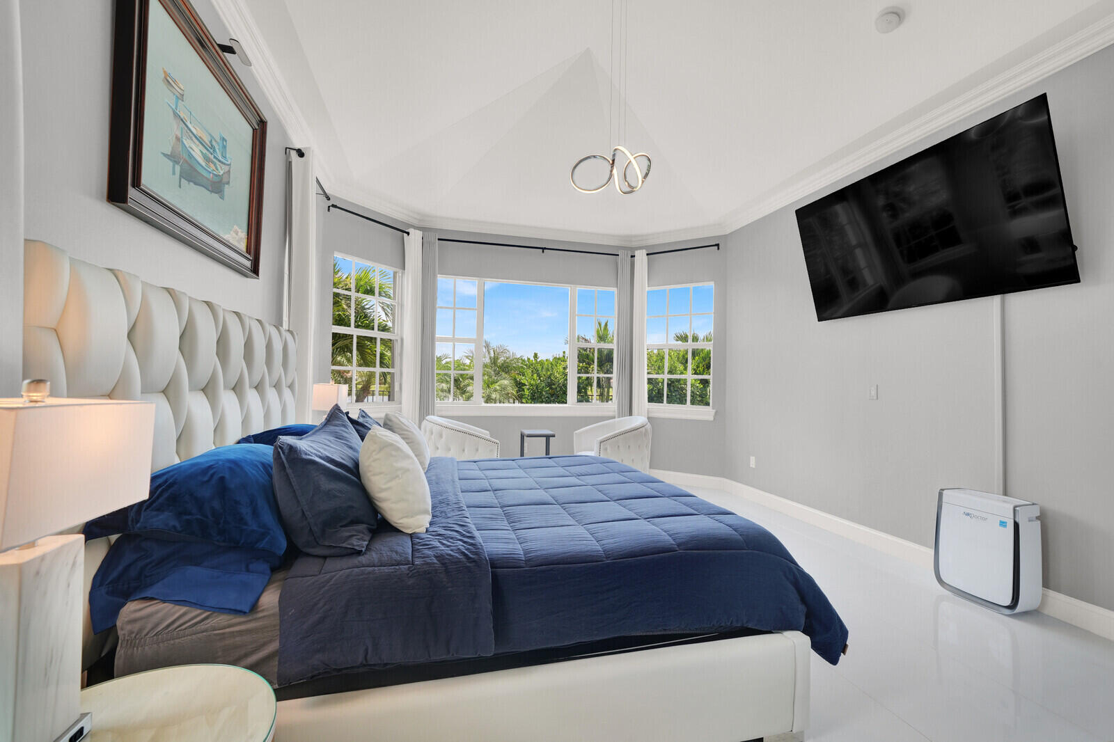 Recessed bedroom featuring a vaulted ceiling with a contemporary chandelier