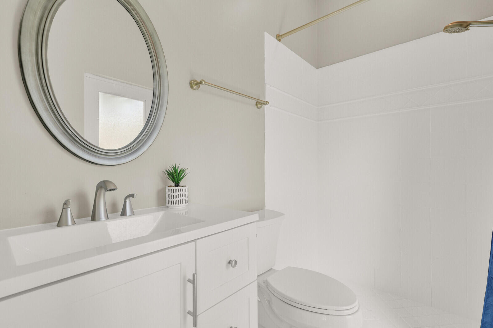 Bathroom vanity with a white countertop and integrated rectangular sink