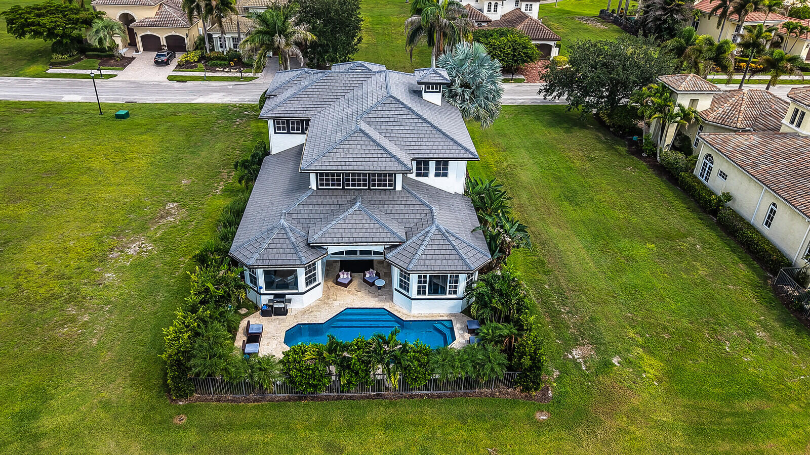 Expansive property featuring a multi-story residence with a complex roofline and multiple window banks