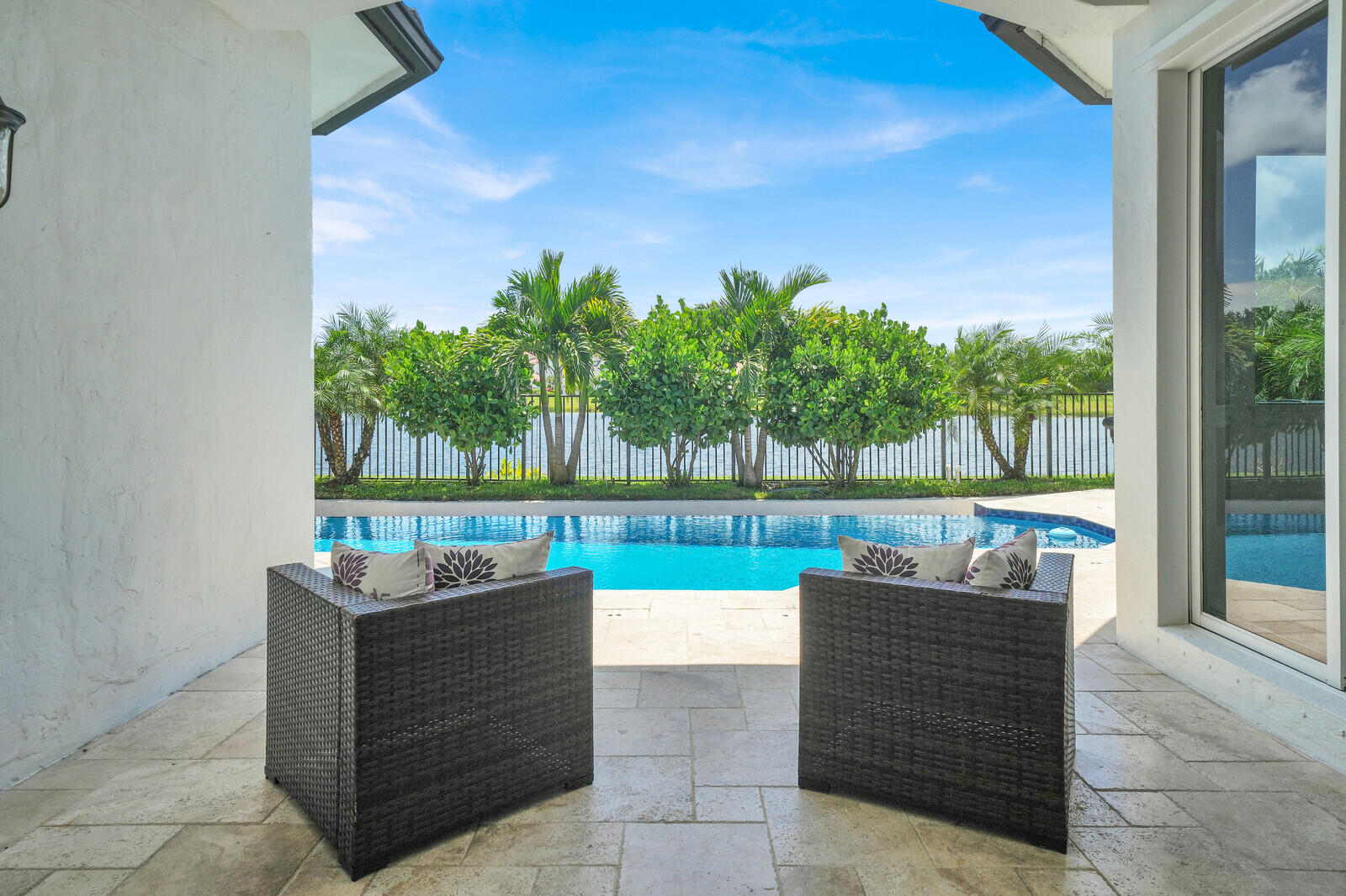 Covered patio with light-toned stone tile flooring