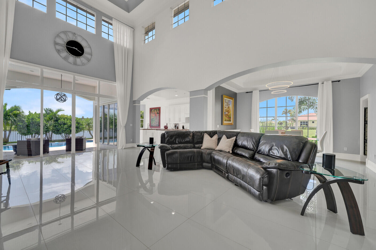Expansive living area featuring high ceilings and large format tile flooring