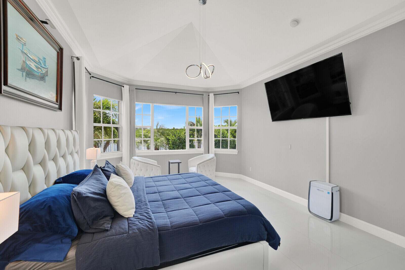 Spacious room featuring a vaulted ceiling and bay window with multiple glass panes